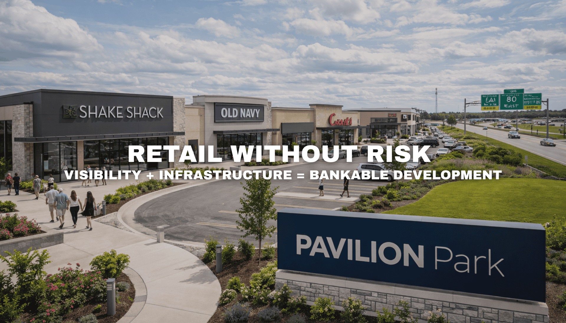 Daytime view of Pavilion Park retail development in West Des Moines, Iowa near I-80 and Grand Prairie Parkway, showing high-visibility storefronts and infrastructure-ready commercial parcels.