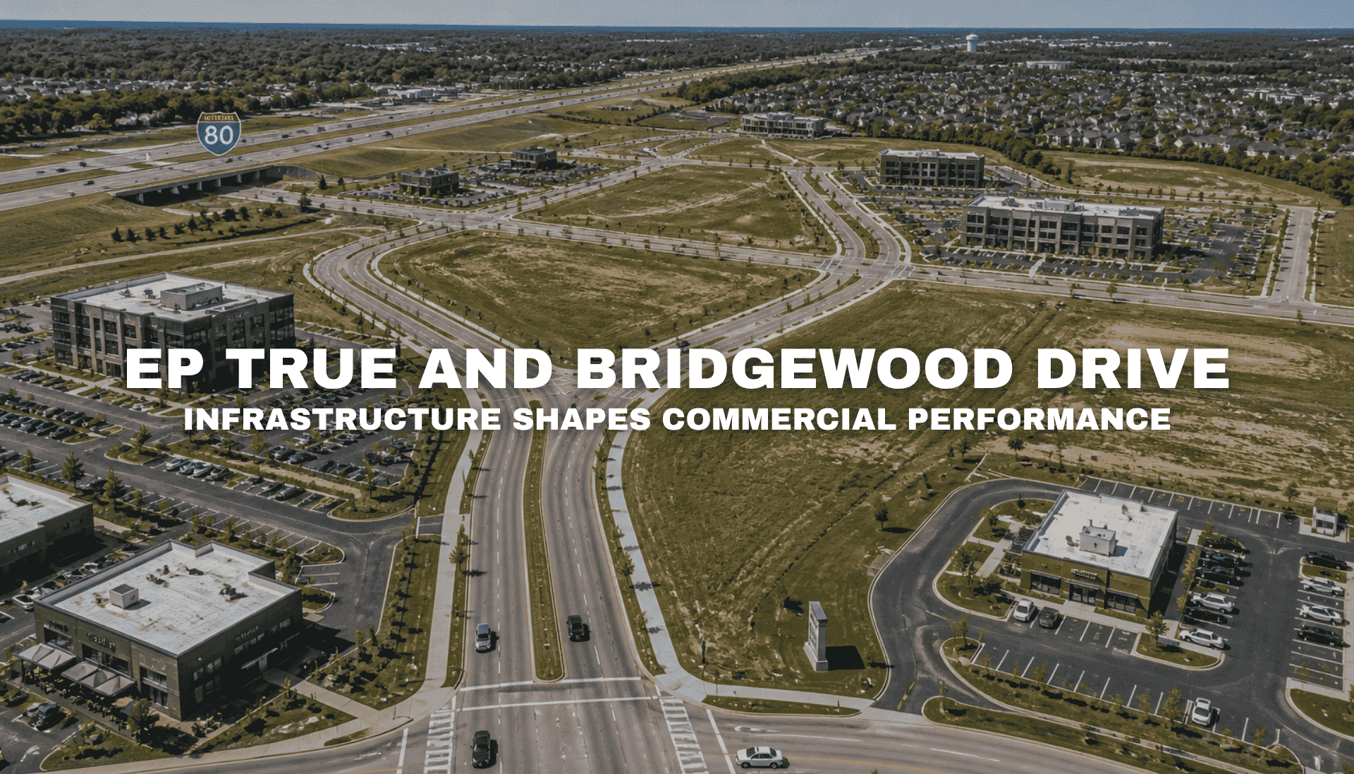 Aerial view of Pavilion Park in West Des Moines with broad roads, open commercial parcels, office buildings, landscaped medians, surrounding neighborhoods, and nearby Interstate 80 access.